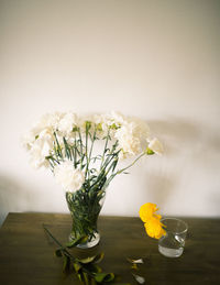 Close-up of yellow flower vase on table