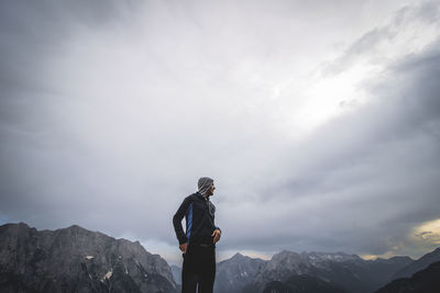 Man standing on mountain against sky