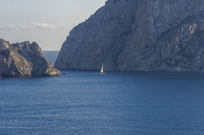 Scenic view of sea and mountains against sky