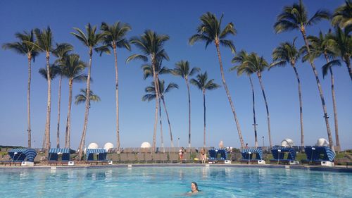 Panoramic view of people on beach against clear sky