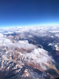 Aerial view of dramatic landscape against blue sky