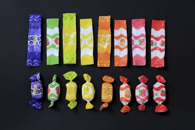 Close-up of candy wrappers on black background