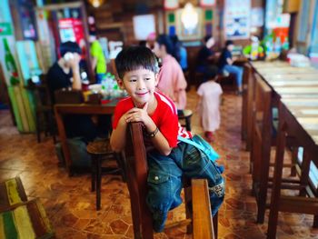 Portrait of boy sitting on chair