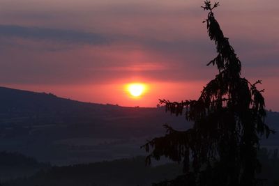 Scenic view of mountains against sky at sunset