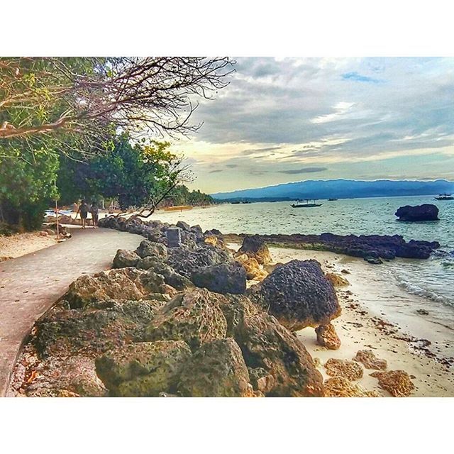 water, sea, beach, tranquil scene, sky, shore, tranquility, scenics, horizon over water, transfer print, beauty in nature, sand, nature, rock - object, auto post production filter, tree, coastline, idyllic, cloud - sky, calm