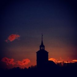 High section of built structure against sky at sunset