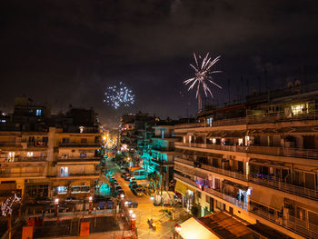 High angle view of firework display at night