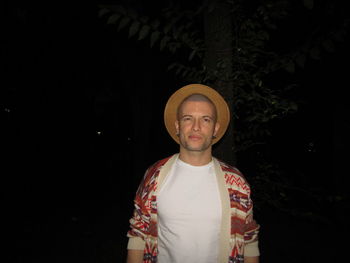 Portrait of young man standing at night