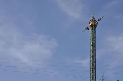 Low angle view of communications tower against sky