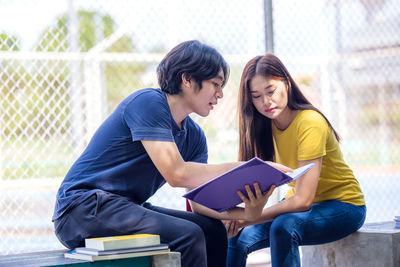 Young couple looking at book