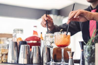Midsection of man preparing cocktail at pub