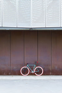 Bicycle parked against wall