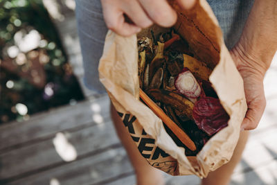 Midsection of woman holding ice cream