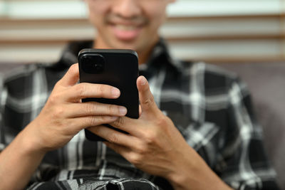 Midsection of woman using mobile phone