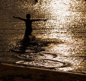 Woman standing by sea