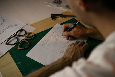 High angle view of man working on table