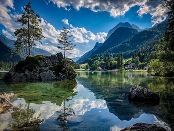 Scenic view of lake and mountains against sky