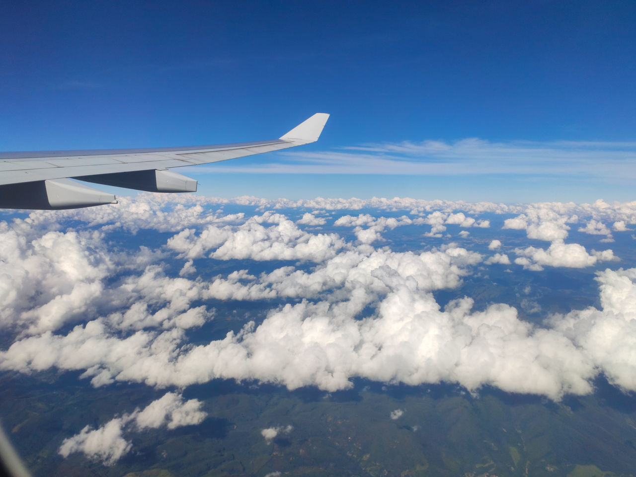 airplane, air vehicle, flying, aircraft wing, transportation, mode of transportation, sky, cloud, aerial view, travel, air travel, nature, aircraft, blue, environment, vehicle, journey, mid-air, aviation, no people, cloudscape, scenics - nature, day, on the move, wing, beauty in nature, outdoors, landscape, high up, window, airliner, motion, above, horizon, vehicle interior