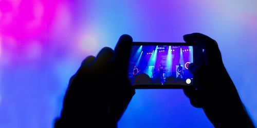 People photographing illuminated smart phone