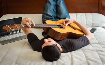 High angle view of man playing guitar