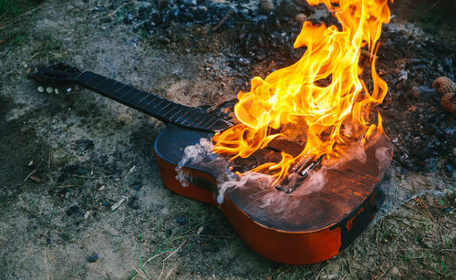 High angle view of fire on acoustic guitar