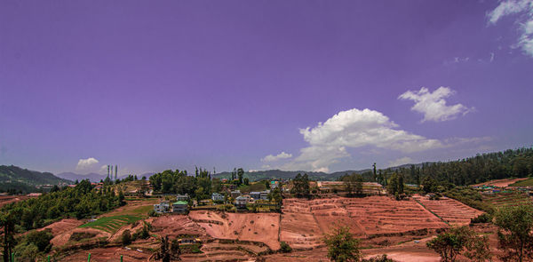 Panoramic view of trees and buildings against sky
