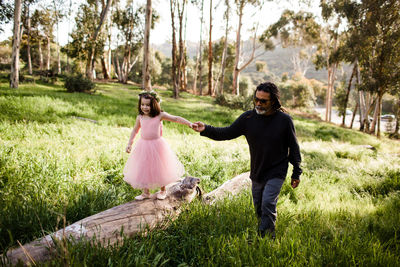 Niece and uncle walking together in field