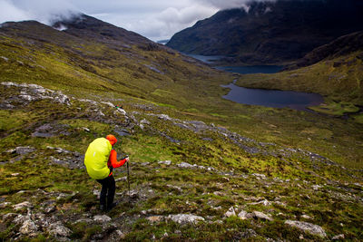 Rear view of person hiking on mountain