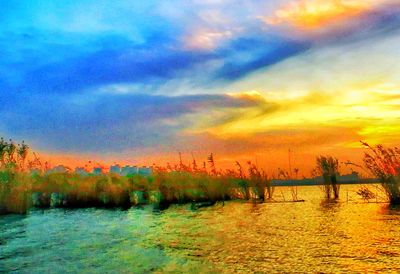 Scenic view of lake against sky during sunset