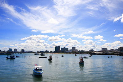 View of boats in river against buildings in city