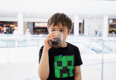 Portrait of boy drinking coffee