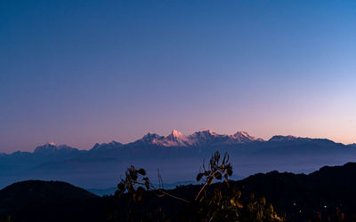 Scenic view of mountains against clear blue sky