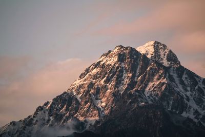 Scenic view of snowcapped mountains against sky during sunset