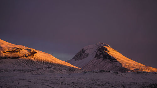 Scenic view of snowcapped mountain against sky during winter