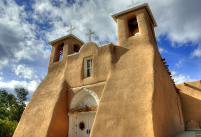 Low angle view of bell tower against sky