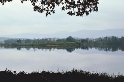 Calm lake with mountains in background