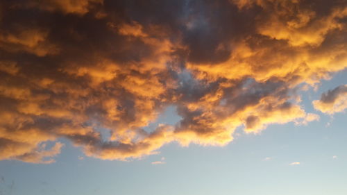 Low angle view of cloudy sky at sunset