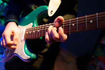 Close-up of man playing guitar