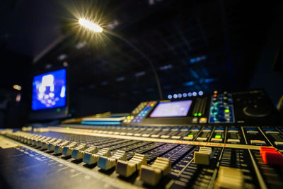 Low angle view of illuminated lighting equipment at night