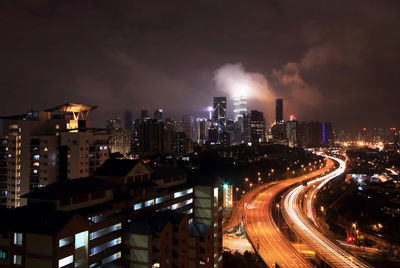 High angle shot of illuminated cityscape against sky at night