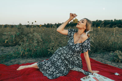 Side view of young woman looking at music