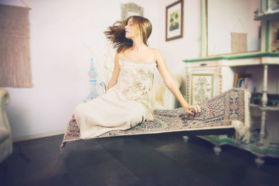 Woman looking at while sitting at home