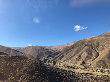 Scenic view of arid landscape against sky