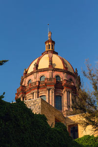 Low angle view of building against clear blue sky