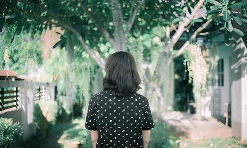 Rear view of a woman standing outdoors