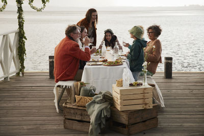 Family having lunch on pier