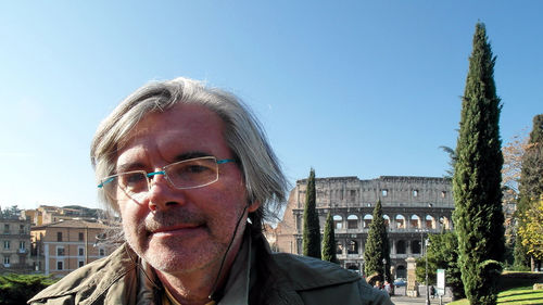 Portrait of man in city against clear sky