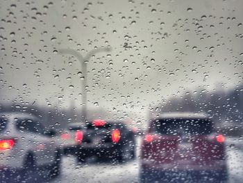 Cars seen through wet window in rainy season