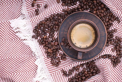 Coffee beans are scattered on the fabric. a close-up photo of freshly roasted coffee of high quality