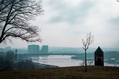 City picture with a river and bridges on a cloudy foggy day